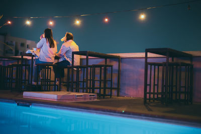 Two woman friend relax in night club at terrace and roof top of restaurant