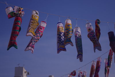 Low angle view of flags against clear sky