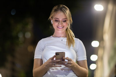 Portrait of young woman using mobile phone