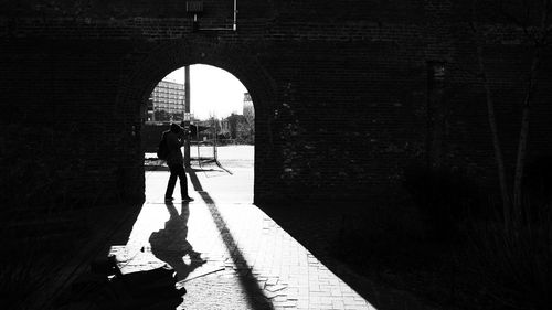 People walking on footpath in city