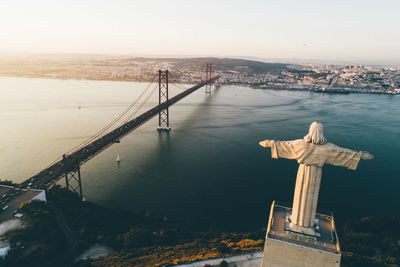 Drone fly by city of lisbon almada and famous 25th april bridge over river tagus 