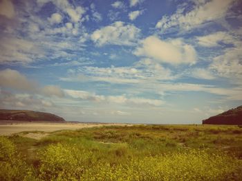 Scenic view of landscape against cloudy sky