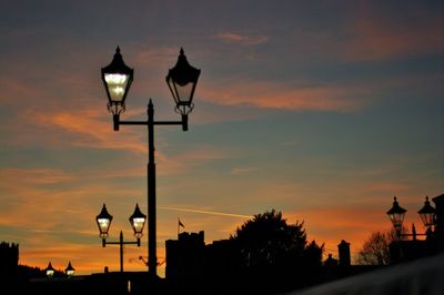 Silhouette street light against sky during sunset