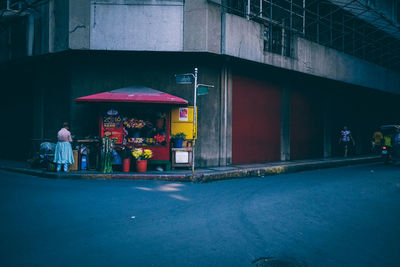 Rear view of woman standing at market stall in city