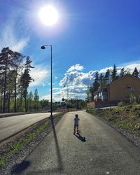 Man on street against sky