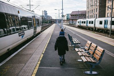 Rear view of woman on railroad station platform