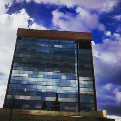 Low angle view of building against cloudy sky