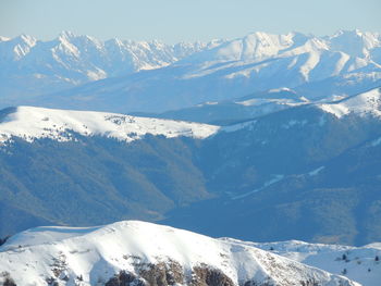 Scenic view of snow covered mountains against sky