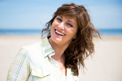 Portrait of smiling mature woman on beach