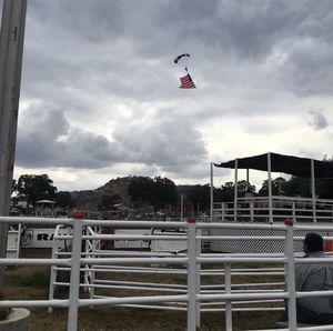 Low angle view of person paragliding against sky