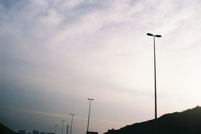 Low angle view of silhouette street light against sky