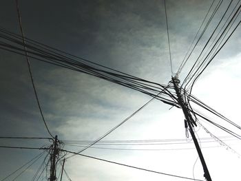 Low angle view of electricity pylon against sky
