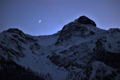 Scenic view of mountains against clear sky at night