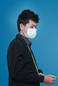 Young man against blue background