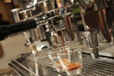Coffee being poured from espresso maker at cafe