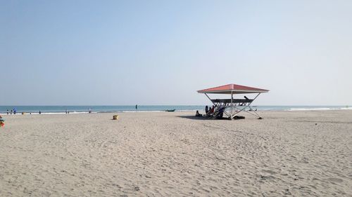 Lifeguard hut on beach against clear sky