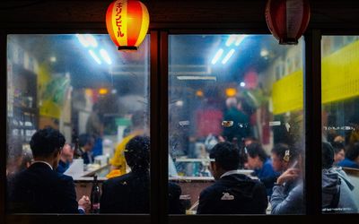 Group of people on glass window at night