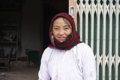 Portrait of a smiling young woman standing outdoors