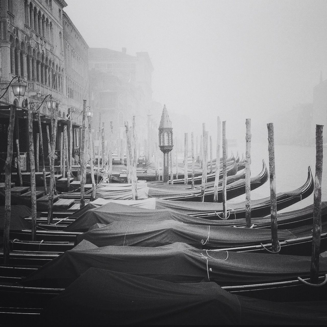 moored, built structure, chair, nautical vessel, architecture, building exterior, in a row, boat, water, absence, empty, day, sky, table, transportation, sea, no people, clear sky, mode of transport, outdoors