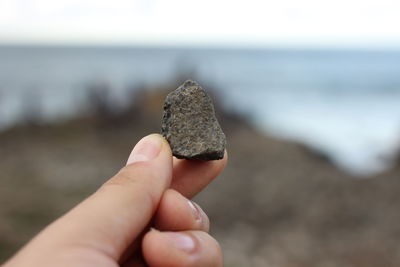 Close-up of hand holding stone