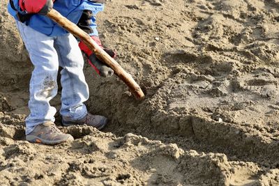 Low section of child working at beach