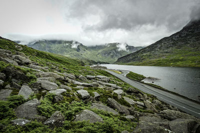 Scenic view of mountains against cloudy sky