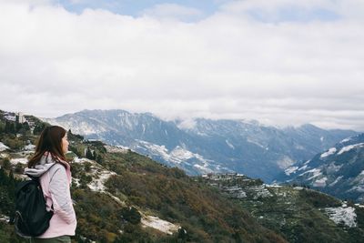 Woman standing on snow covered mountain