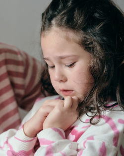 Upset little girl being consoled by mom