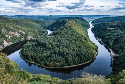 Panoramic view of river amidst trees against sky