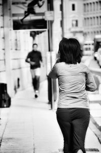 Rear view of people walking in city