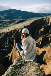 Woman sitting on rock