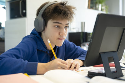 Portrait of boy sitting on table