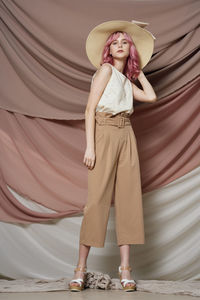 Full length portrait of a smiling young woman