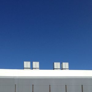Low angle view of built structure against clear blue sky