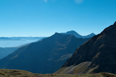 Scenic view of mountains against clear blue sky