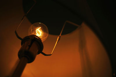 Low angle view of illuminated light bulb