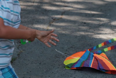 Midsection of boy playing with kite