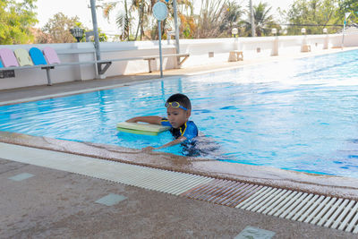 Smiling boy swimming in pool