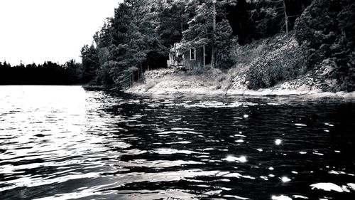 Scenic view of river with trees in background