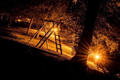 View of illuminated street lights at night