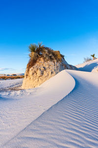 Scenic view of desert against blue sky