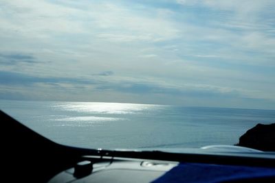 Scenic view of sea seen through car windshield