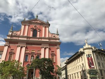 Low angle view of clock tower against sky