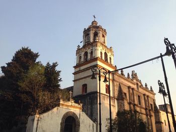 Low angle view of clock tower against sky