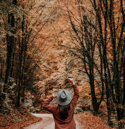 Rear view of person standing in forest