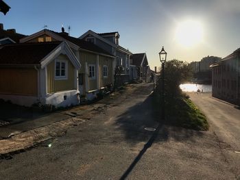 Street amidst houses and buildings against sky