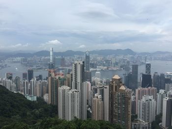 Cityscape against cloudy sky