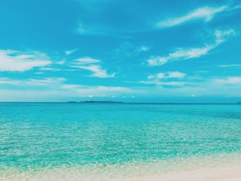 Scenic view of sea against blue sky