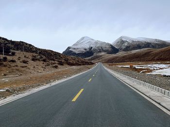 Empty road against mountain
