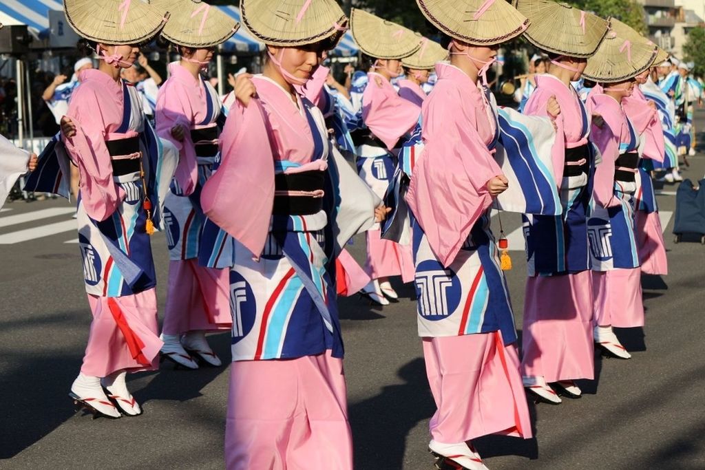 PANORAMIC VIEW OF PEOPLE IN MULTI COLORED UMBRELLA